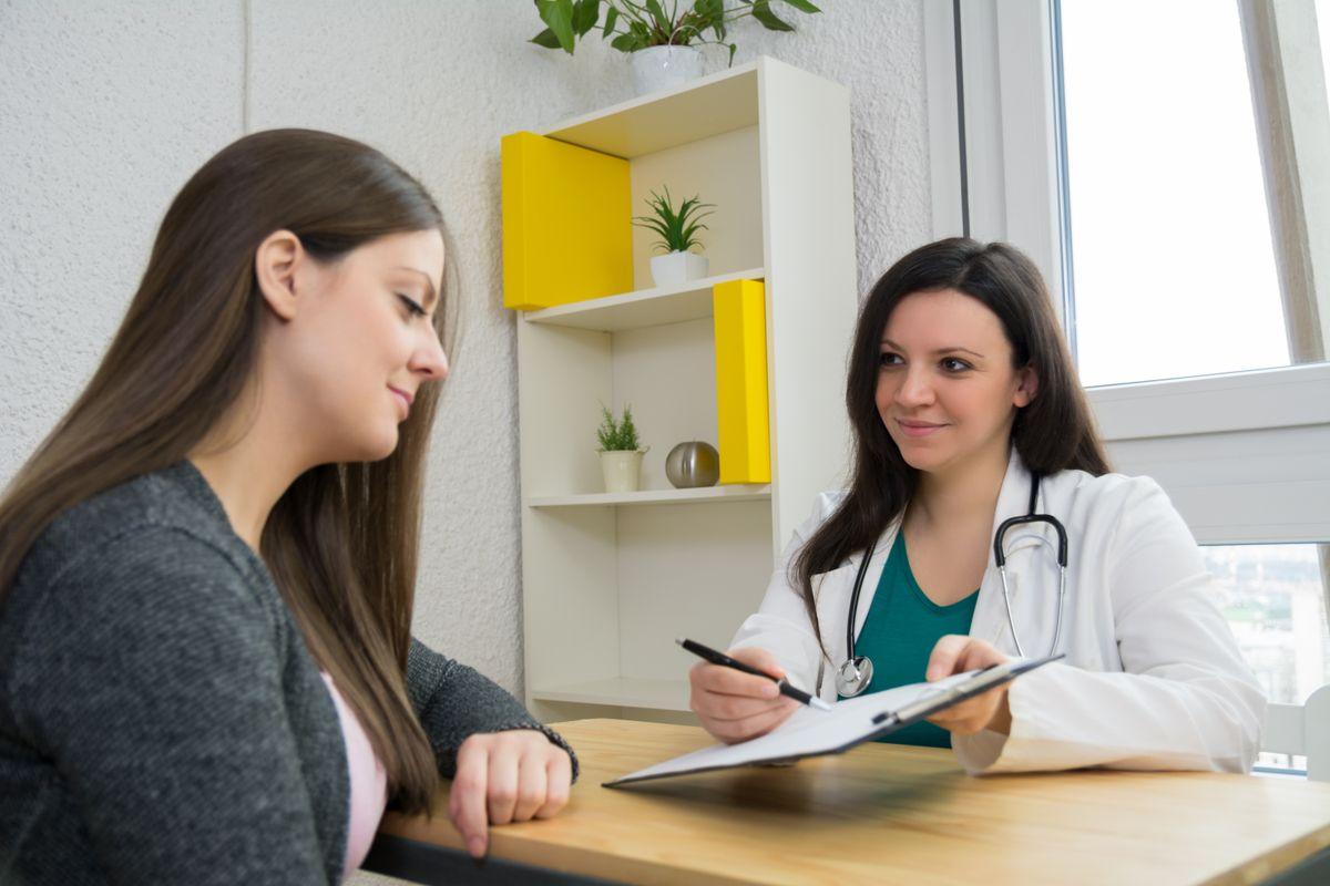 Beautiful female doctor giving advice to a female patient